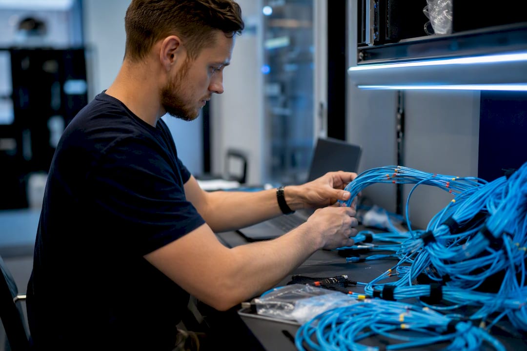 Hands mapping network cables in server room