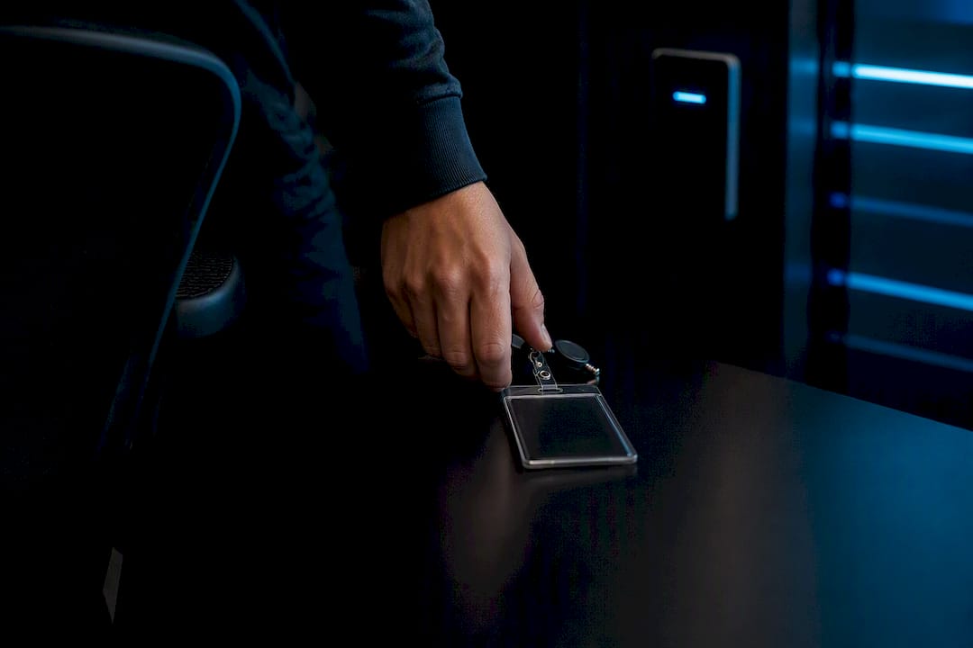 Hand removing security badge at SOC shift change